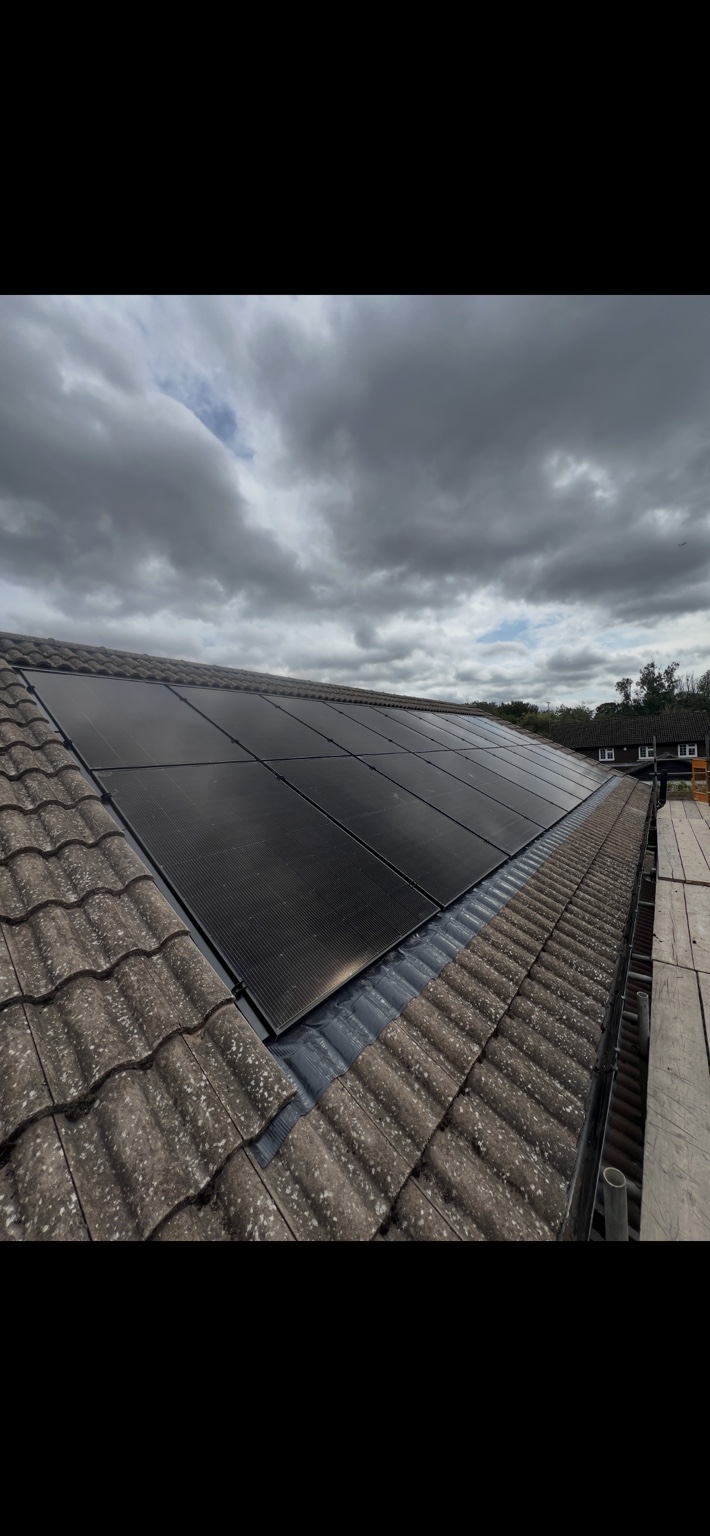 Completed black solar panel array fitted neatly to a tiled residential roof